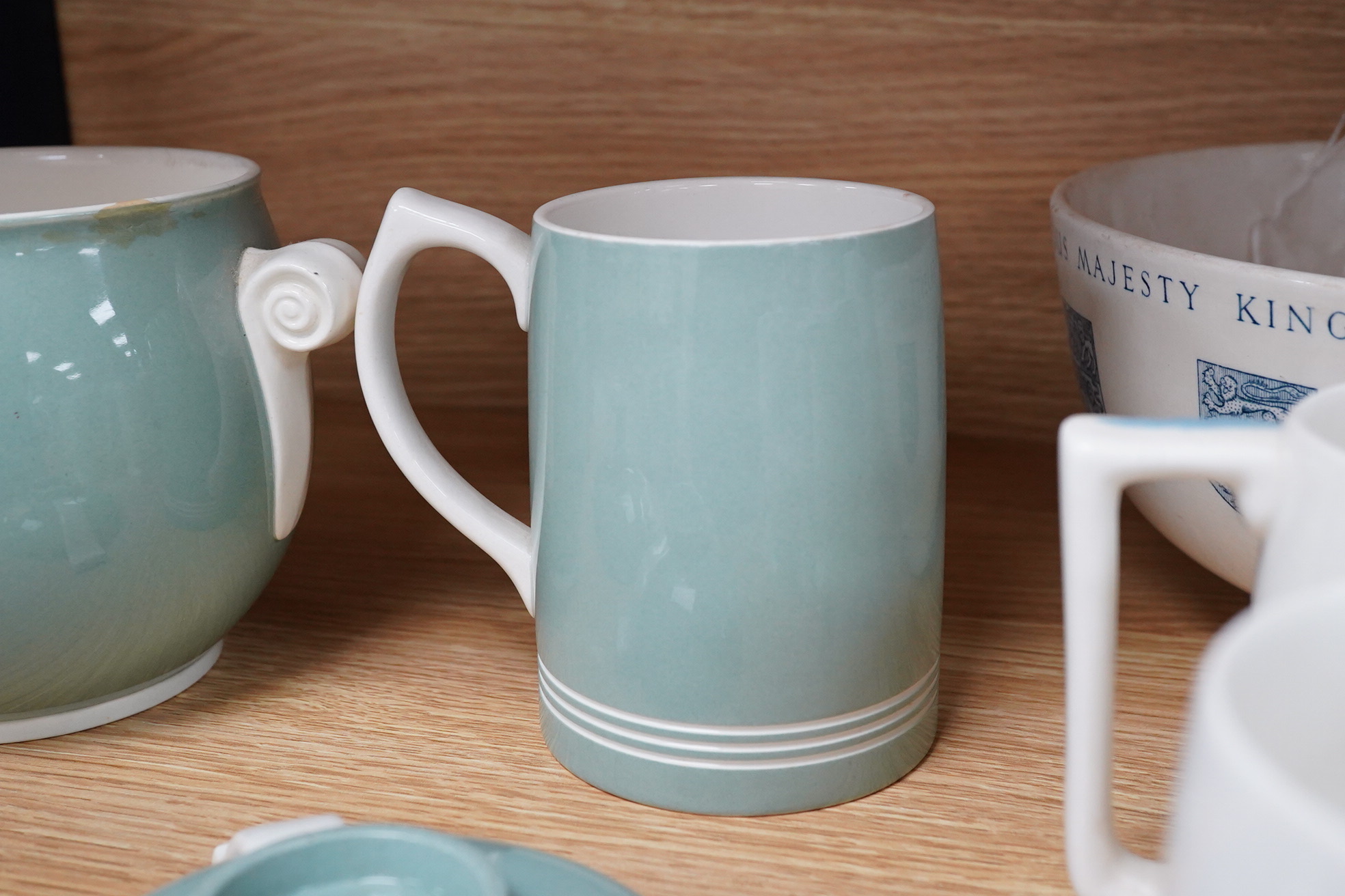 Keith Murray for Wedgwood - a celadon mug, two handled vase and two tazzas, tallest 13cm